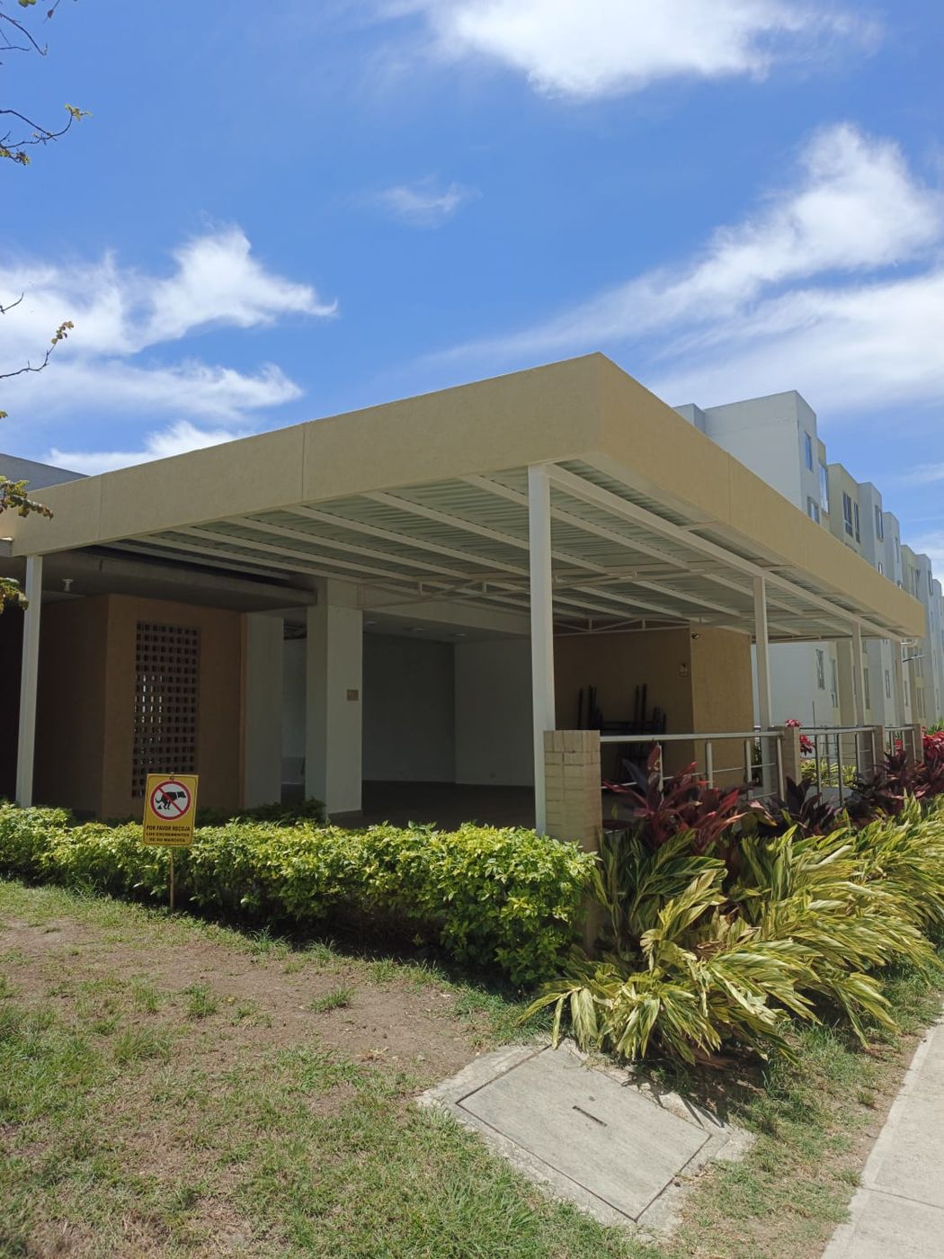 Salón comunal con cubierta de estructura metálica y borde pintado
